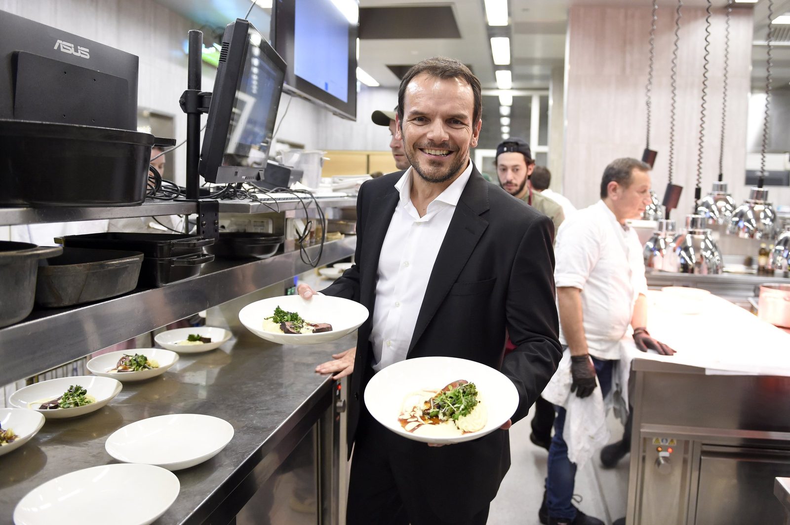 Gastgeber präsentiert einen Gang in der Küche bei der Charity-Gala der Foundation